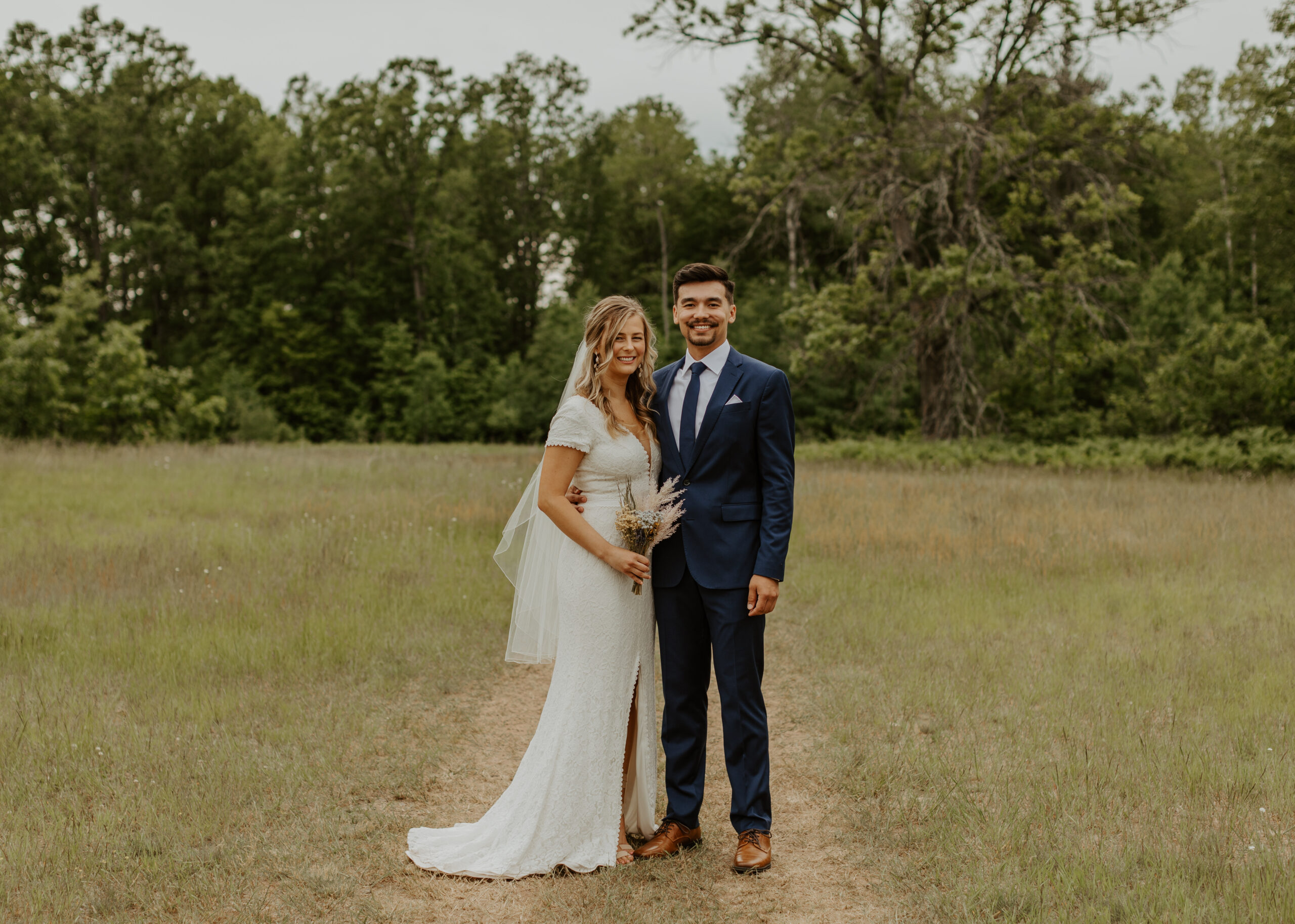 Bride and Groom pose on the property of The Atrium wedding venue in Solon Springs, Wisconsin