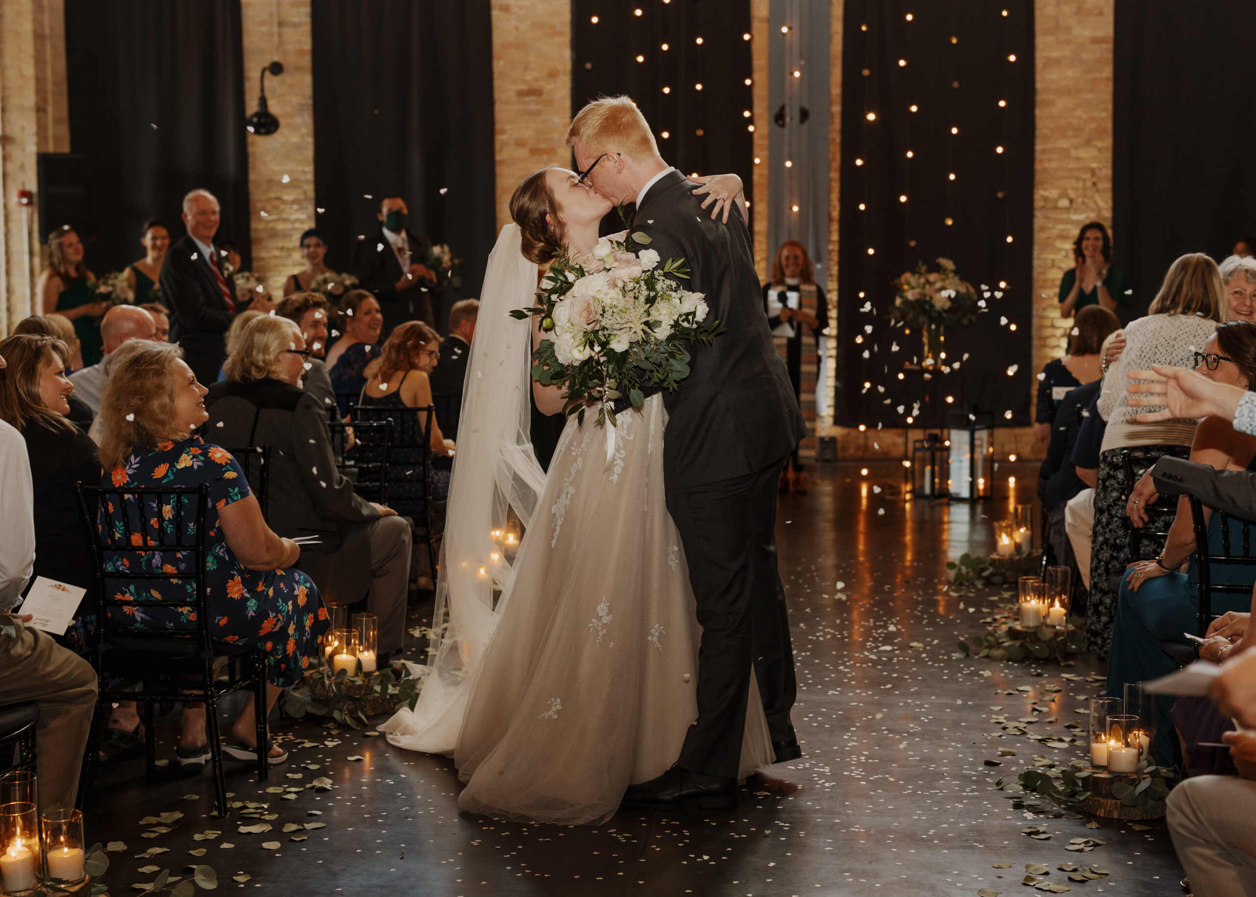 Bride and Groom kiss after their wedding ceremony at Clyde Iron Works in Duluth, Minnesota