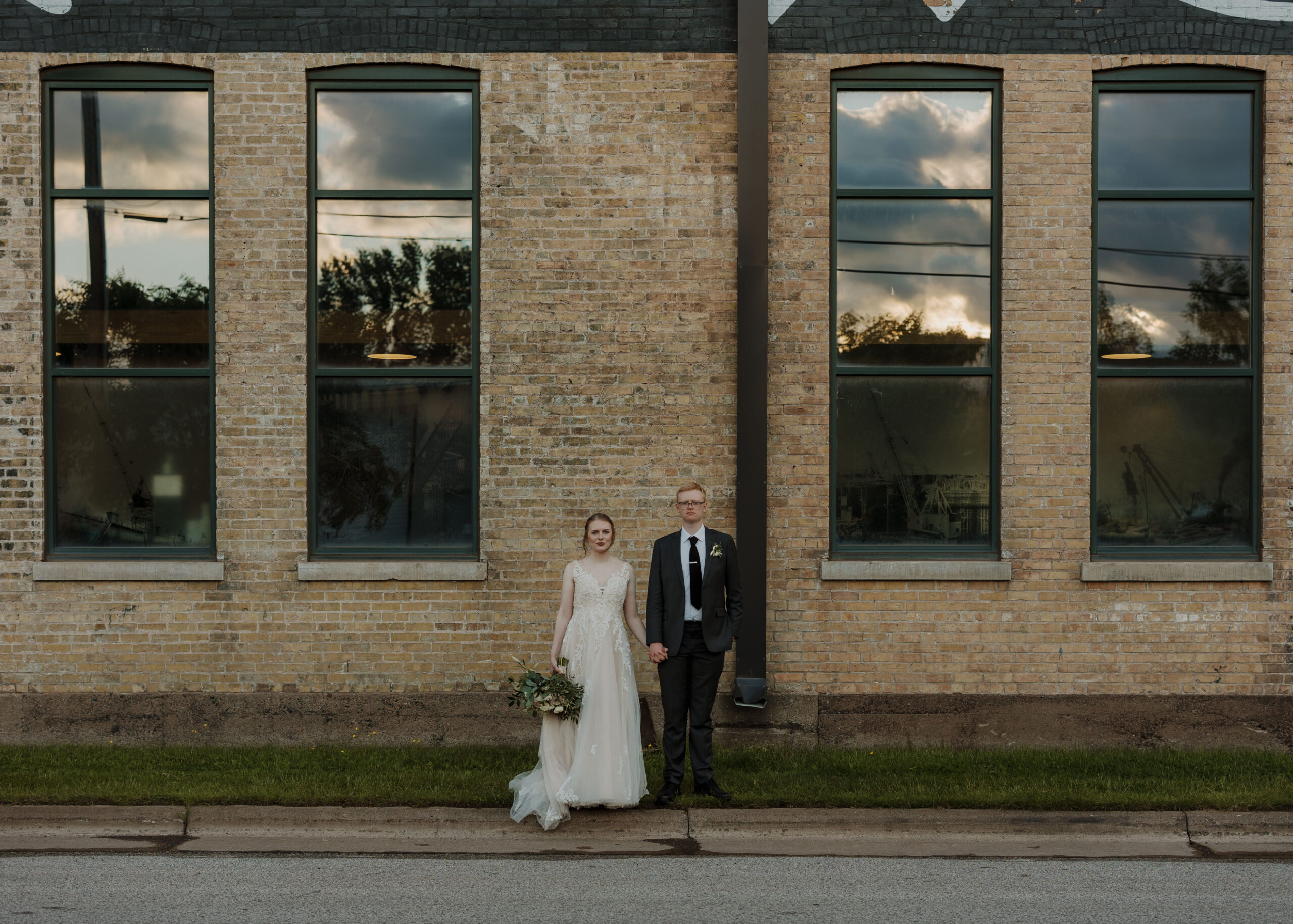 Bride and Groom pose outside of Clyde Iron Works in Duluth, Minnesota