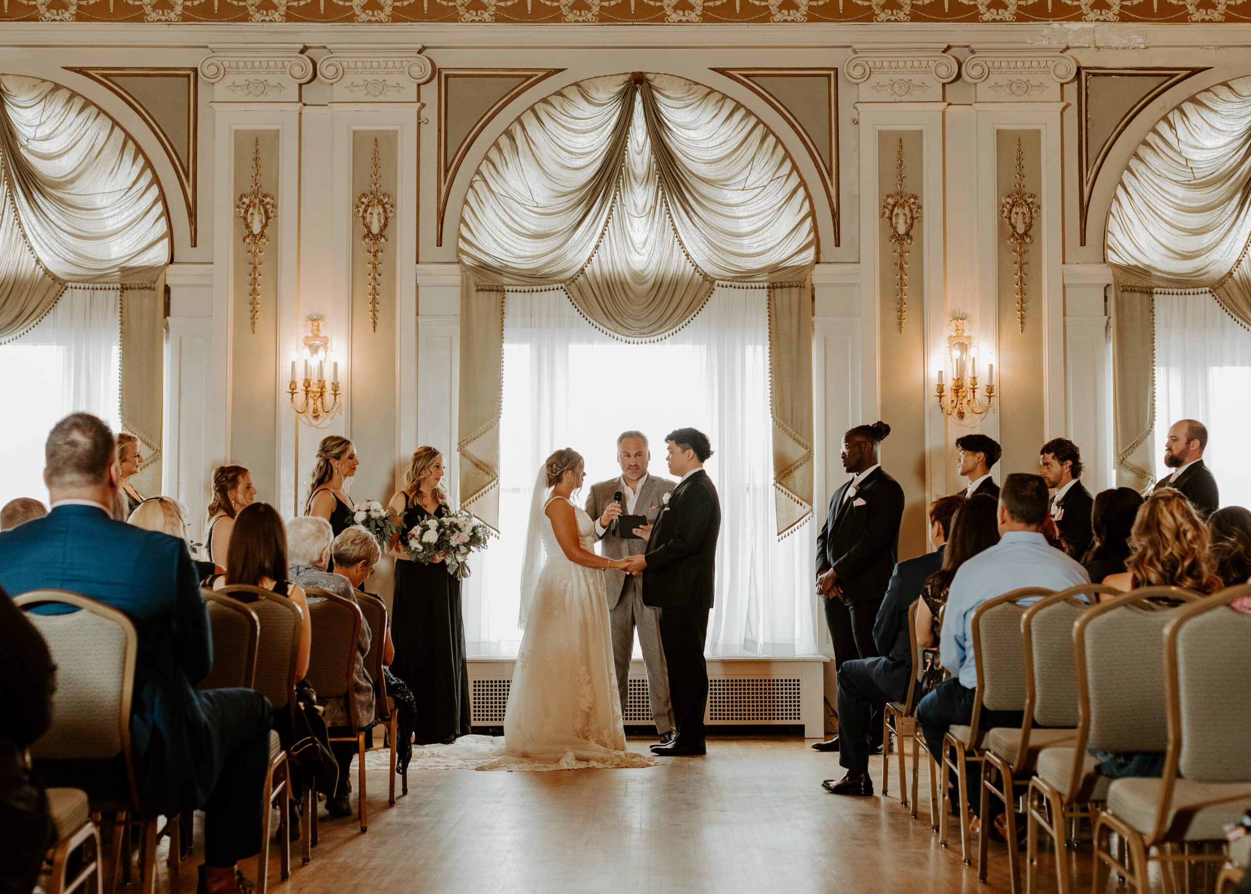 Bride and Groom stand in front of their wedding ceremony at Greysolon Ballroom in Duluth, Minnesota