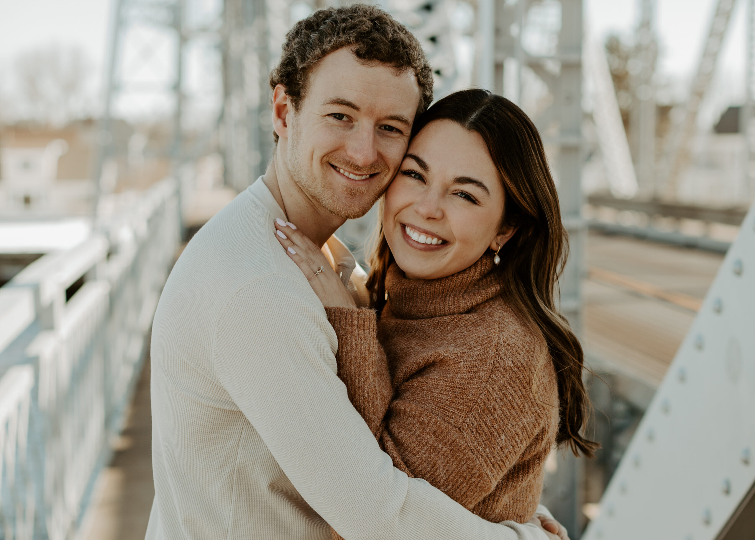 Couple embraces on the Aerial Lift Bridge in Canal Park, Duluth, Minnesota during their engagement photos