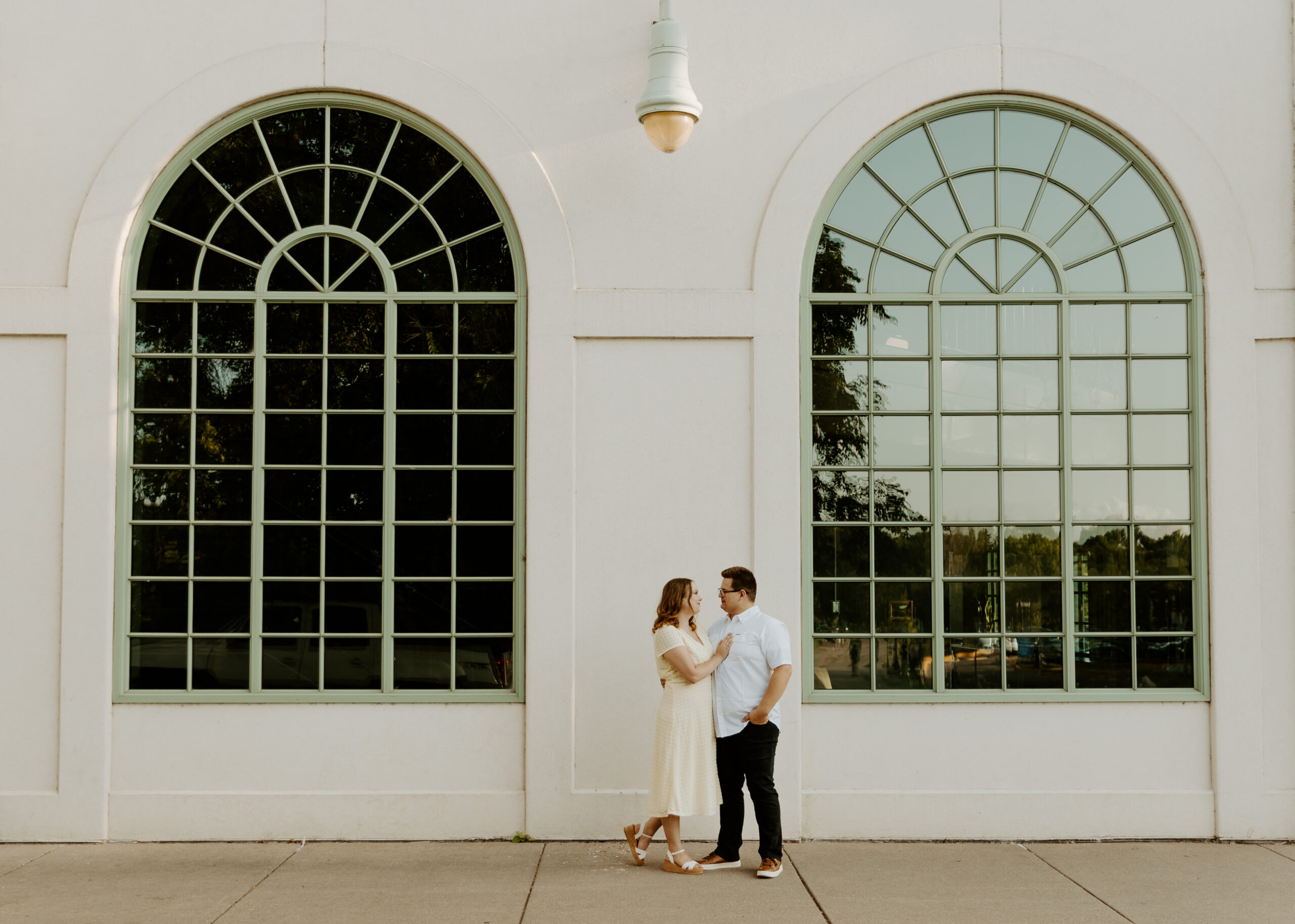 Couple poses in front of Como Lakeside Pavillion in St. Paul, Minnesota during their engagement photos