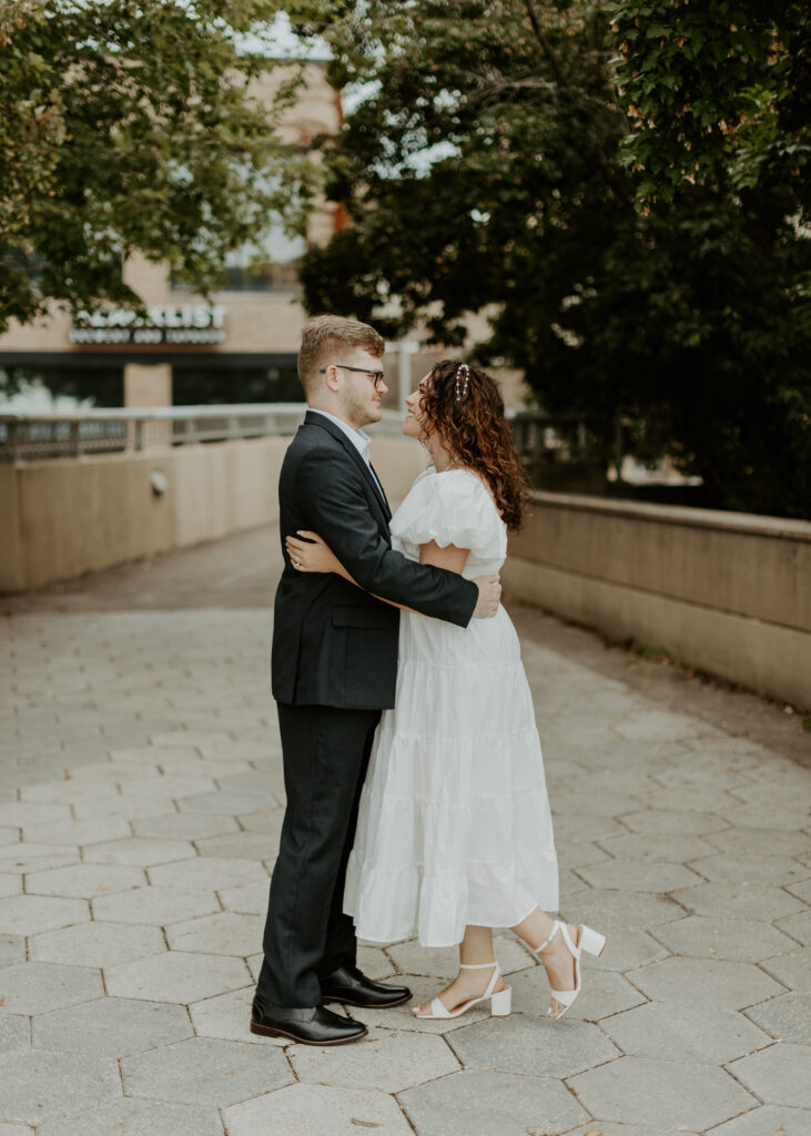 Couple embraces outside of Greysolon Ballroom during their Duluth Minnesota engagement photo session