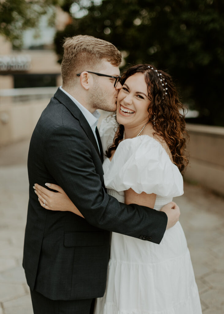 Couple embraces outside of Greysolon Ballroom during their Duluth Minnesota engagement photo session