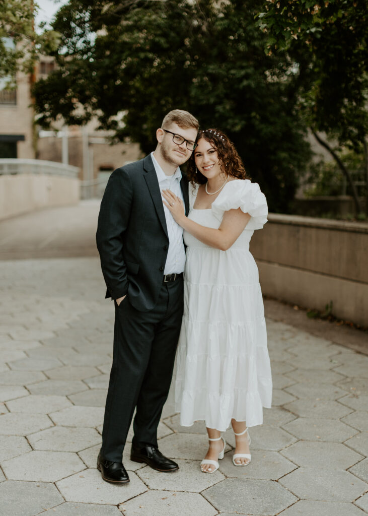 Couple embraces outside of Greysolon Ballroom during their Duluth Minnesota engagement photo session