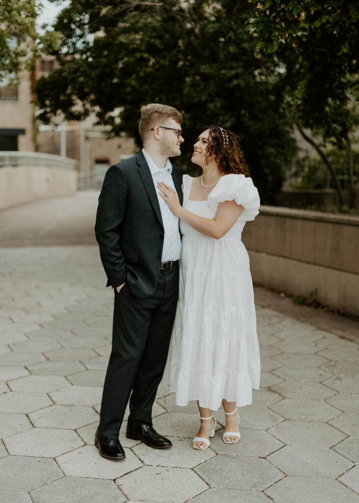 Couple embraces outside of Greysolon Ballroom during their Duluth Minnesota engagement photo session