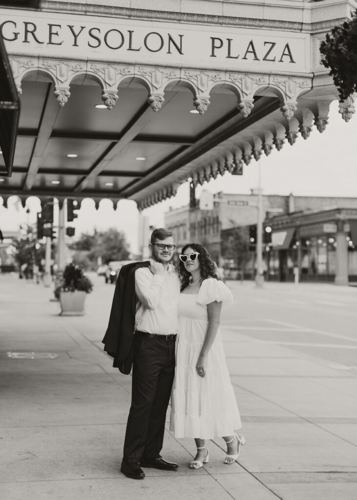 Couple embraces outside of Greysolon Ballroom during their Duluth Minnesota engagement photo session