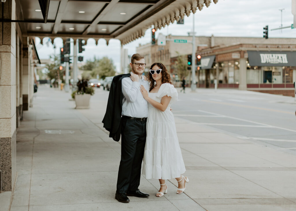 Couple embraces outside of Greysolon Ballroom during their Duluth Minnesota engagement photo session