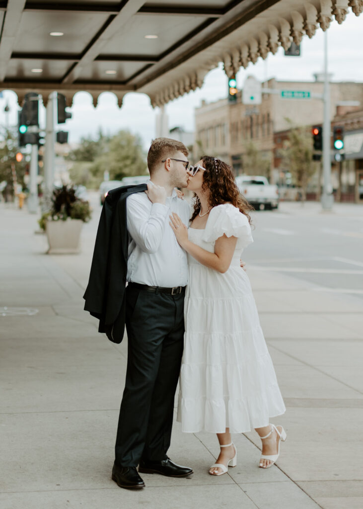 Couple kisses outside of Greysolon Ballroom during their Duluth Minnesota engagement photo session