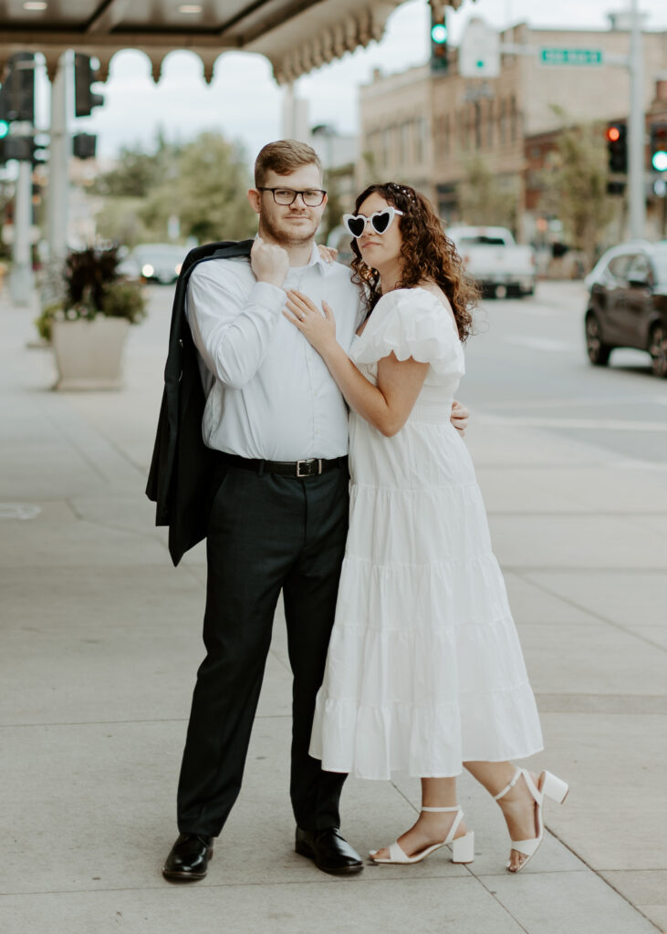 Couple embraces outside of Greysolon Ballroom during their Duluth Minnesota engagement photo session