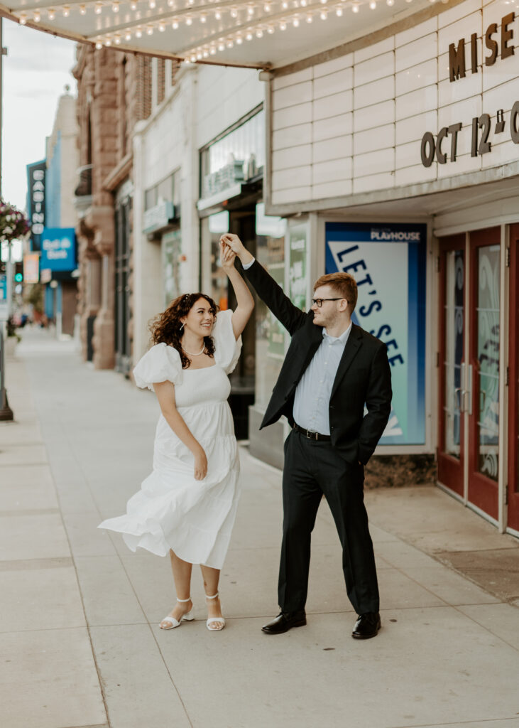 Couple dances outside of Greysolon Ballroom during their Duluth Minnesota engagement photo session