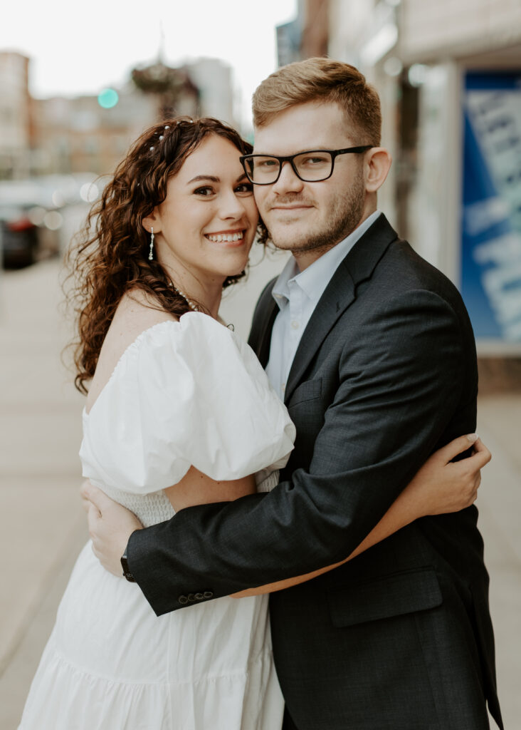 Couple embraces outside of Greysolon Ballroom during their Duluth Minnesota engagement photo session