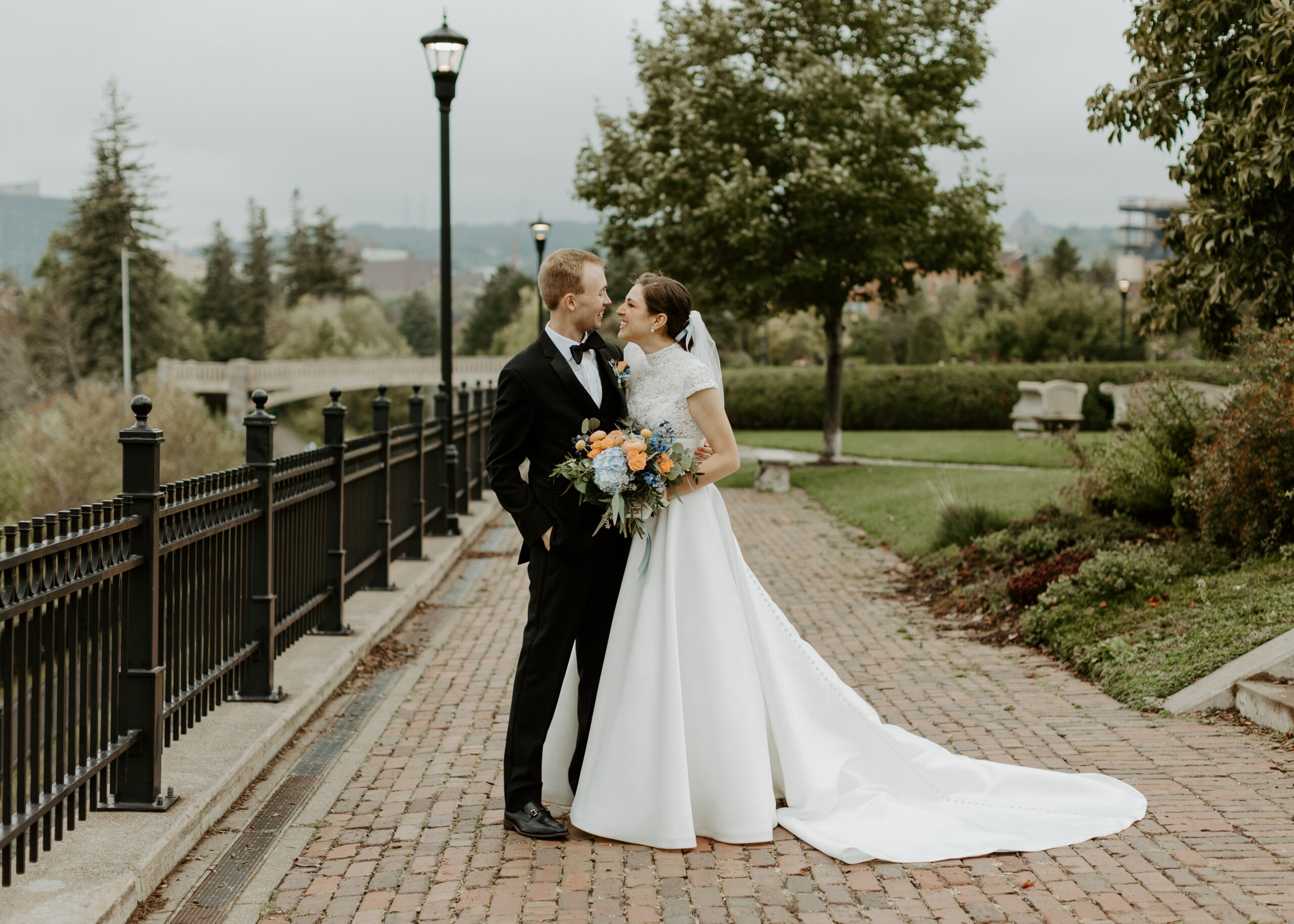 Couple embraces at The Rose Gardens in Duluth, Minnesota after their elopement ceremony photographed by Ashlyn Meys Photography