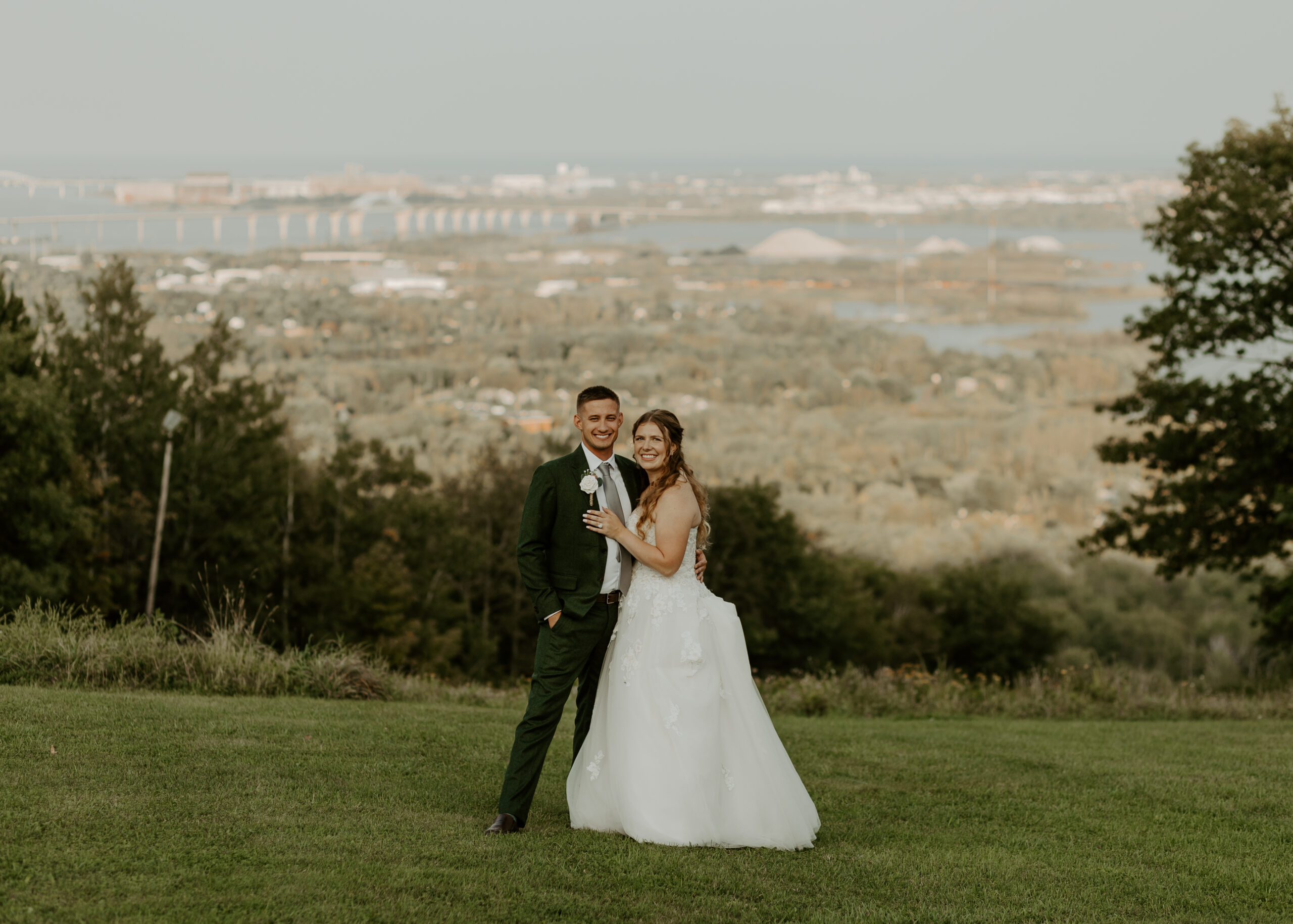 Bride and Groom stand outside of Spirit Mountain in Duluth Minnesota overlooking Lake Superior