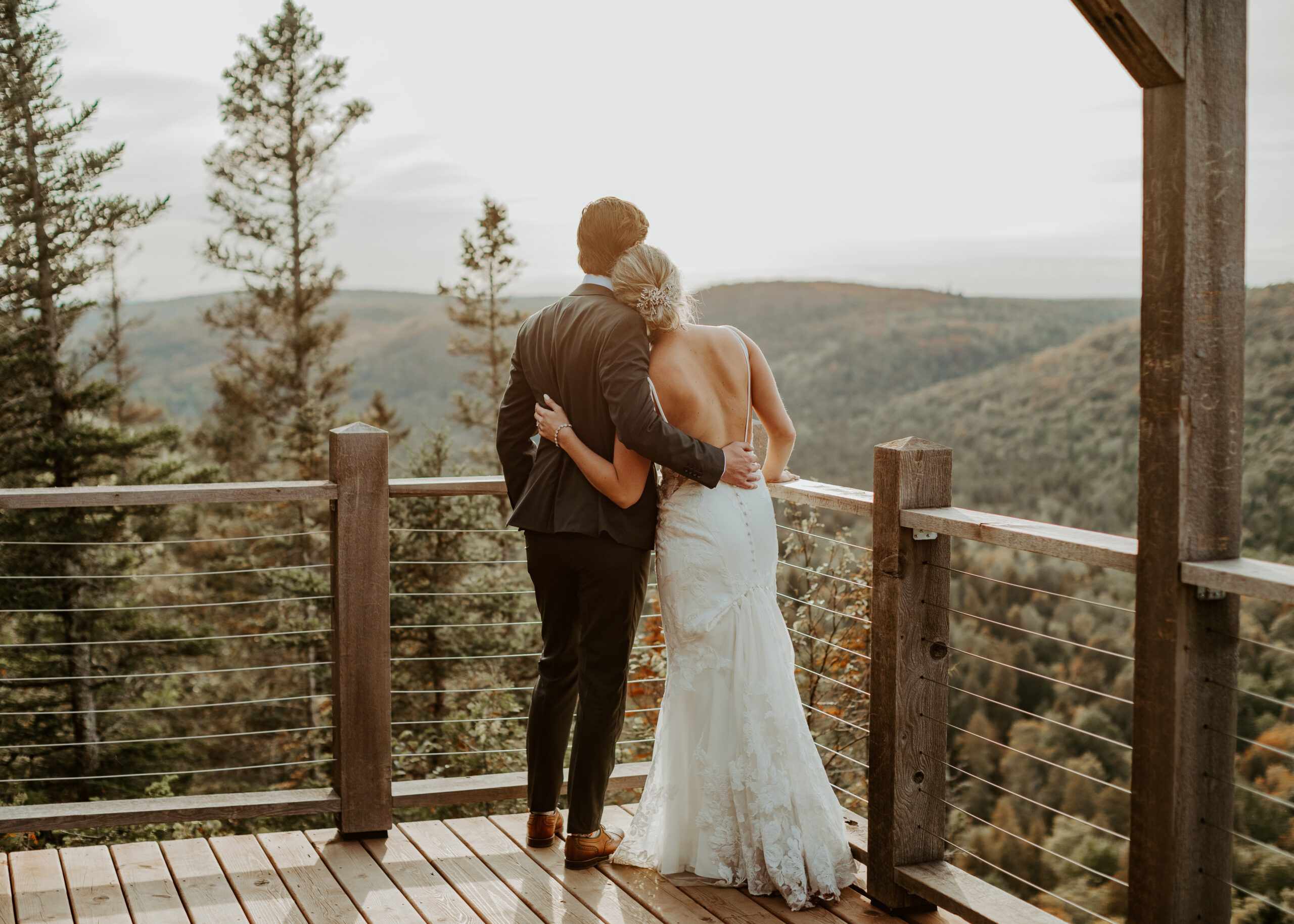 Bride and Groom stand at overlook on Lutsen Mountain in Lutsen Minnesota at their fall wedding