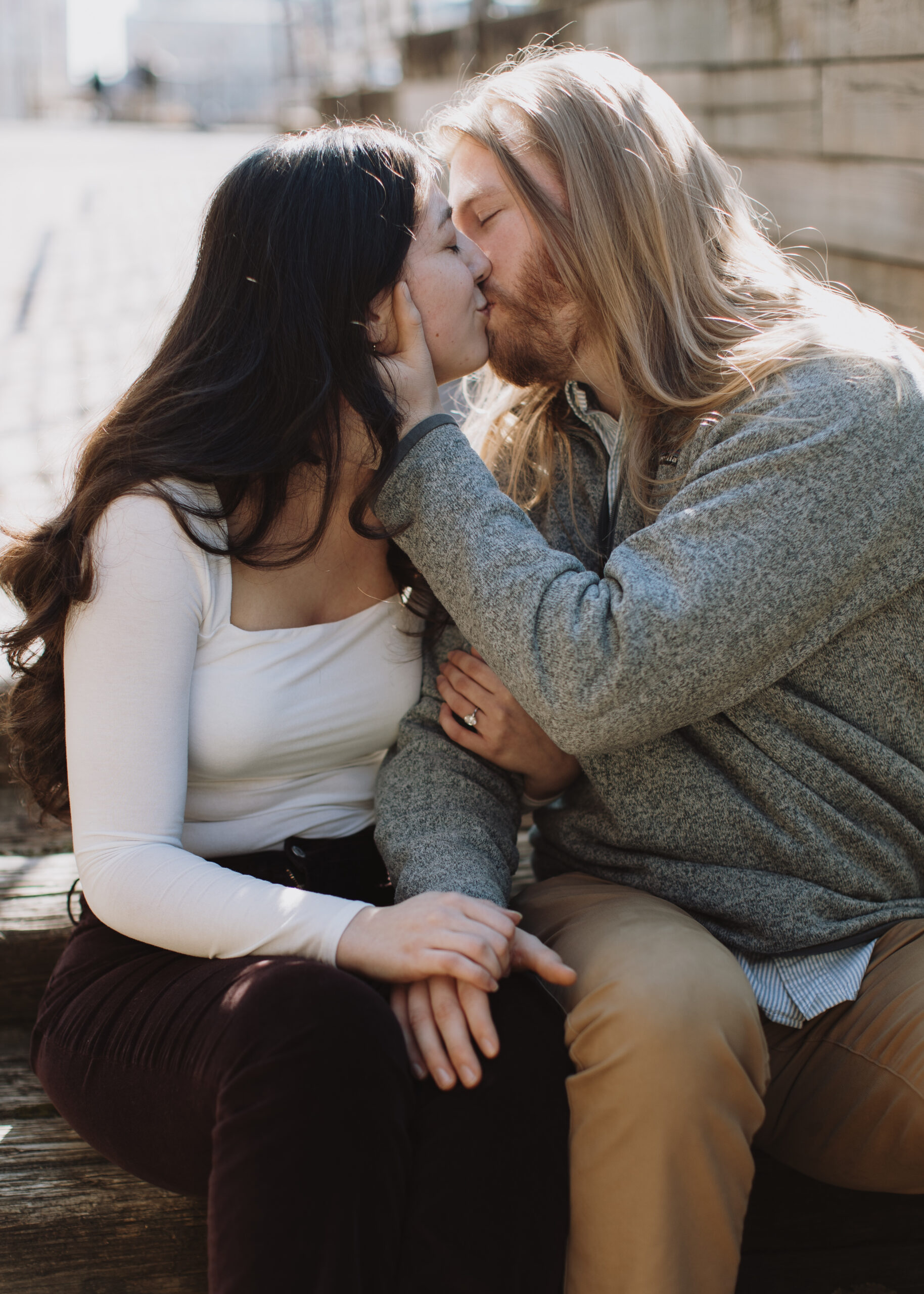 couple kisses during engagement photo session at St. Anthony Main in Minneapolis, Minnesota