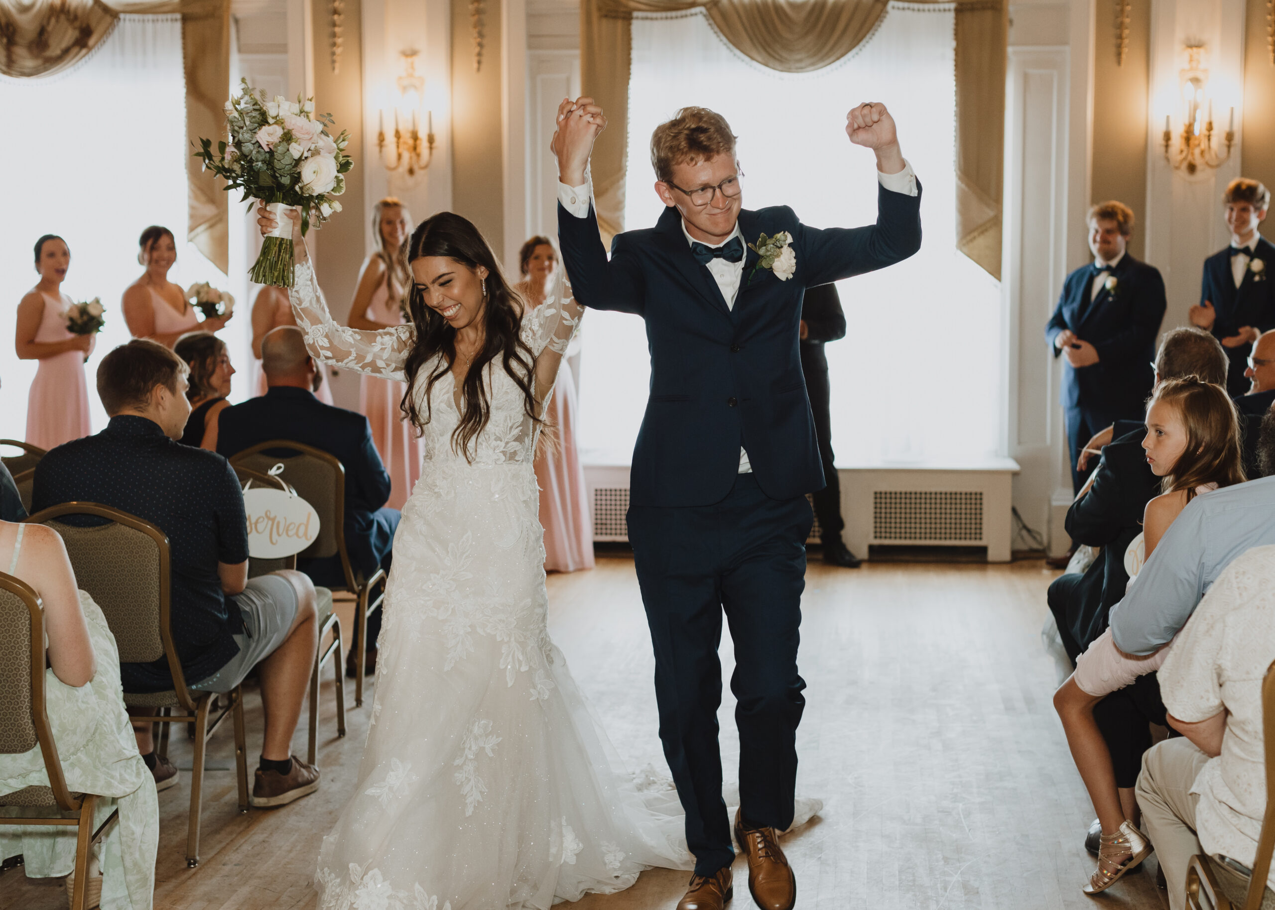 Bride and Groom dance down the aisle after saying "I do" at Greysolon Ballroom in Duluth, Minnesota