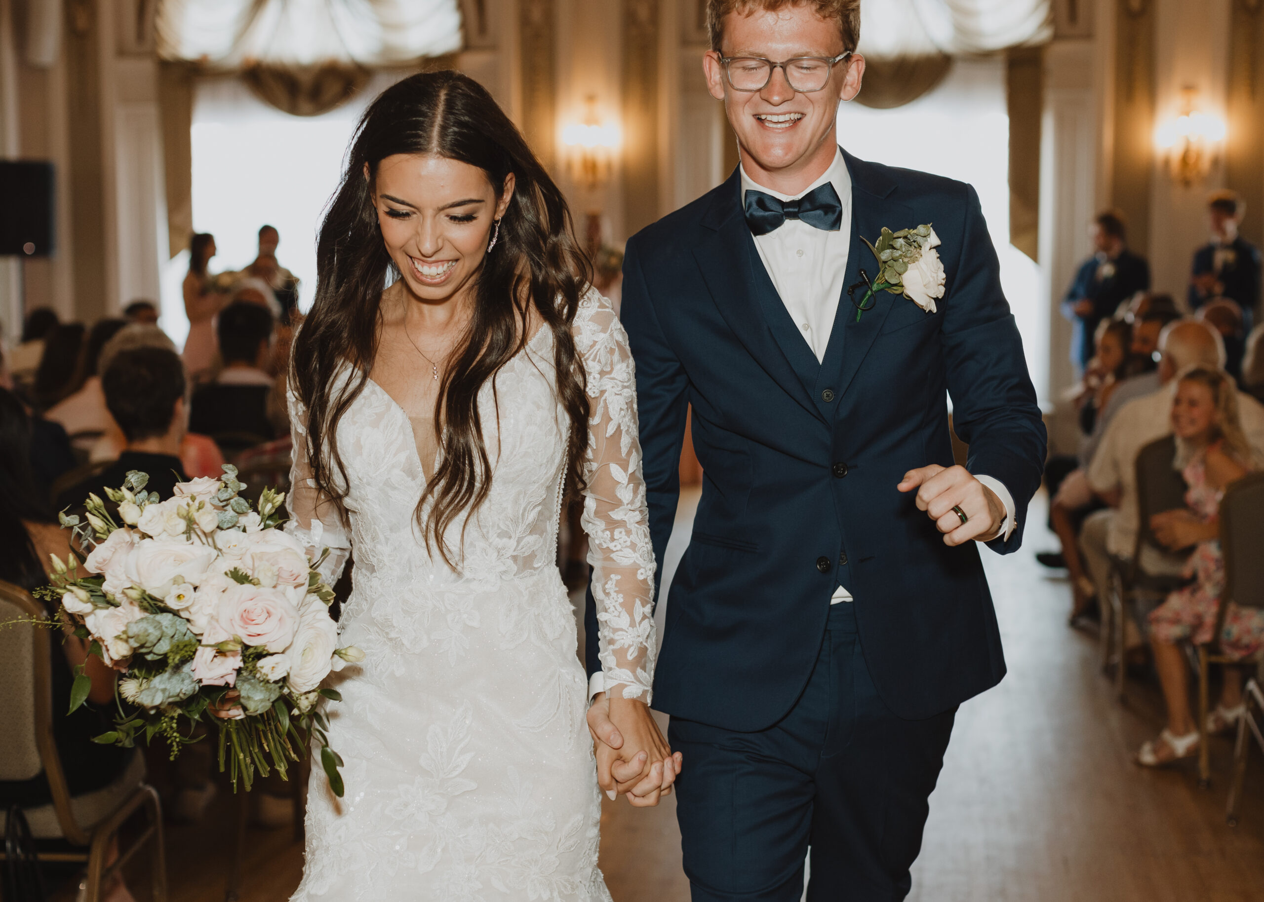 Bride and Groom dances down the aisle after their wedding ceremony at Greysolon Ballroom in Duluth, Minnesota